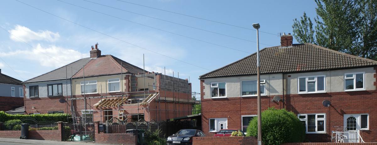 Semi-detached houses with an extension under construction